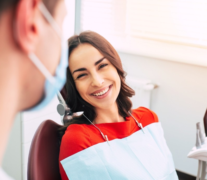 Woman in dental office chair smiling