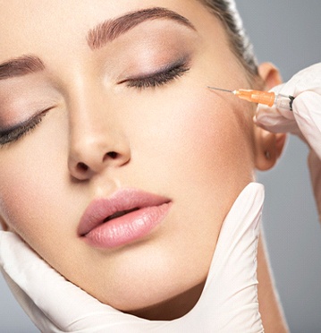 Woman tilting head back for Botox in Albuquerque