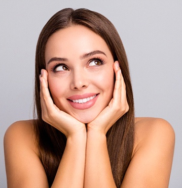 Smiling woman resting chin on hands after Botox in Albuquerque