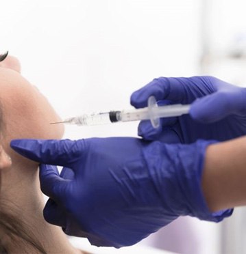 Patient receiving BOTOX injection near her jaw