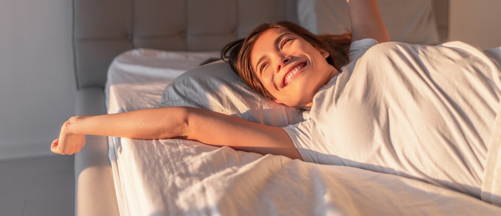 Woman waking feeling rested thanks to sleep apnea treatment