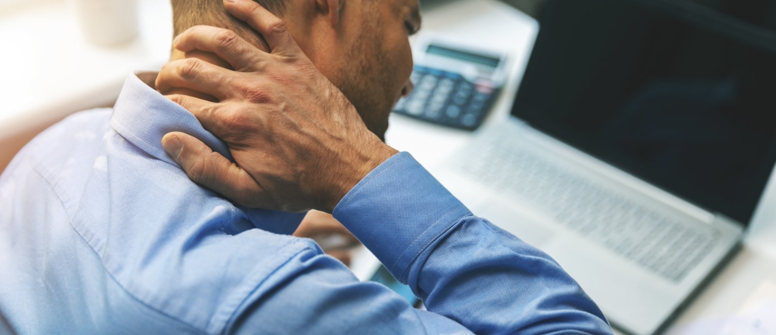 Man in need of T M J therapy holding jaw in pain