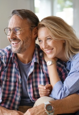 Man and woman smiling after esthetic treatment