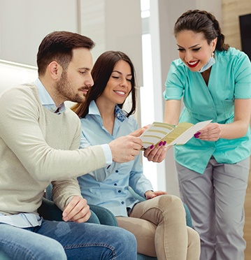 Couple learning about in network vs out of network dental insurance coverage