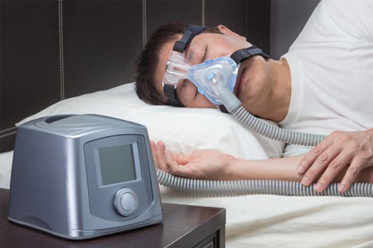 Man in CPAP mask in bed 