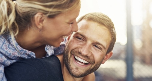 Man and woman smiling after esthetic treatment