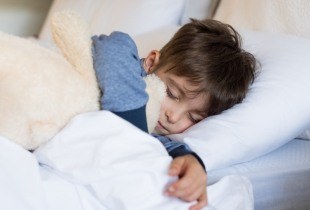 Child sleeping soundly in bed