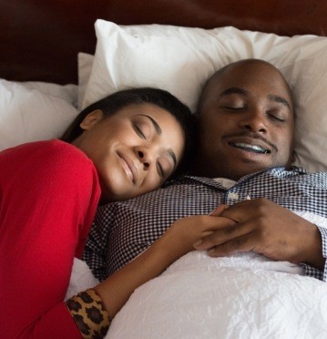 Man and woman sleeping soundly thanks to sleep apnea treatment