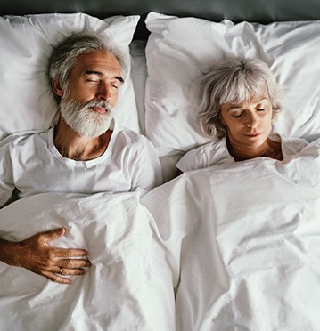 Couple sleeping peacefully thanks to successful snoring treatment