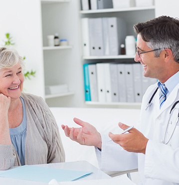 Patient smiling while learning about laser snoring treatment