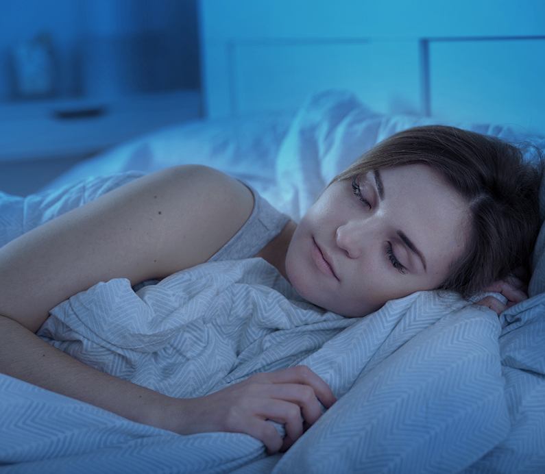 Woman in bed with Vivos sleep apnea treatment in Albuquerque New Mexico