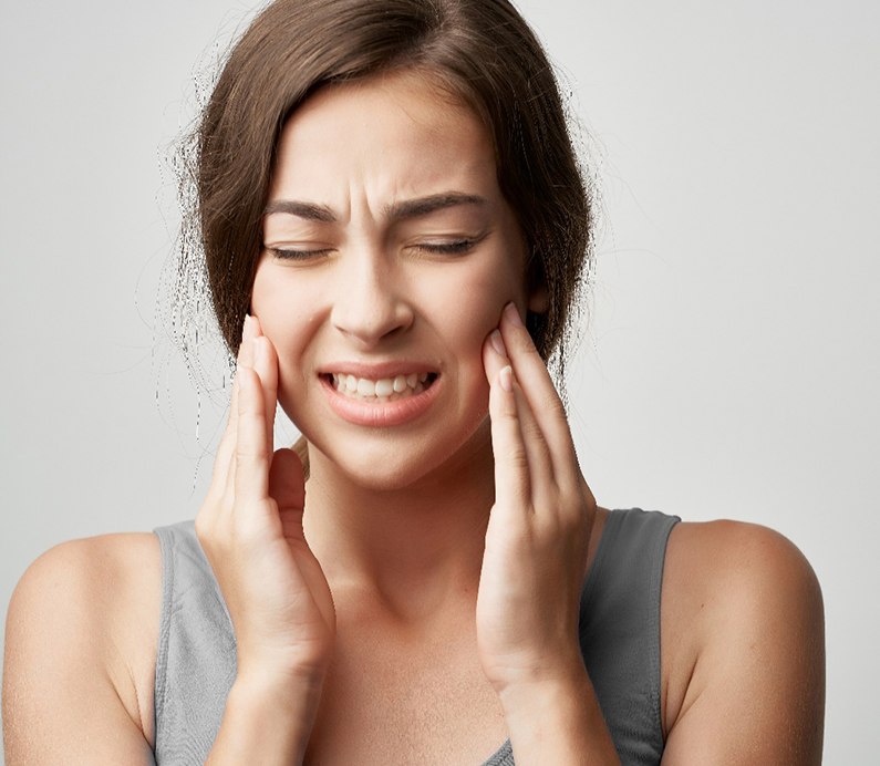 Woman feeling the pain of a TMJ disorder in Albuquerque, NM