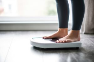 Woman’s feet on weight scale