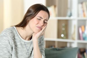 Woman suffering from TMJ pain